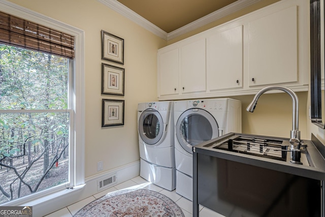 laundry area featuring light tile patterned flooring, visible vents, washer and dryer, cabinet space, and crown molding