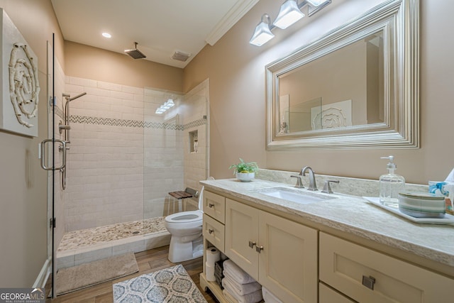 full bath featuring a stall shower, vanity, toilet, and wood finished floors