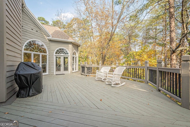 wooden deck with french doors and area for grilling