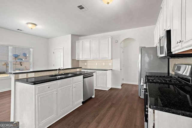 kitchen featuring sink, white cabinets, dark wood-type flooring, and appliances with stainless steel finishes