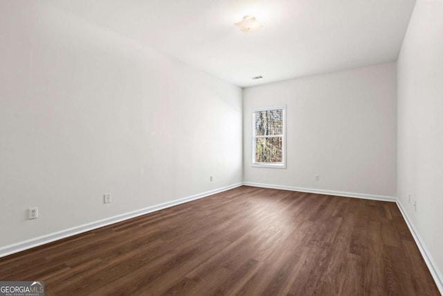 spare room featuring dark hardwood / wood-style floors