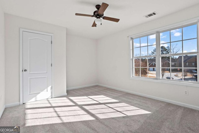 carpeted empty room with ceiling fan