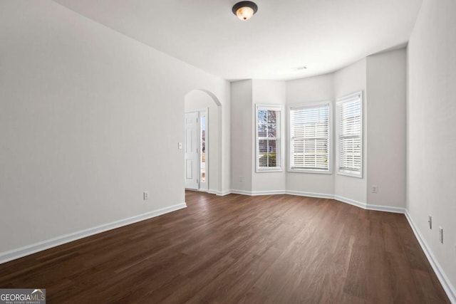 spare room with dark wood-type flooring