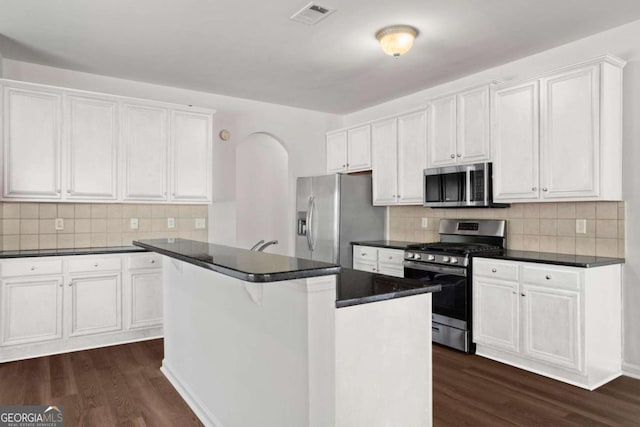 kitchen featuring a center island, appliances with stainless steel finishes, and white cabinetry