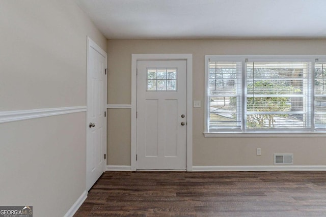 entrance foyer with dark wood-type flooring and a healthy amount of sunlight