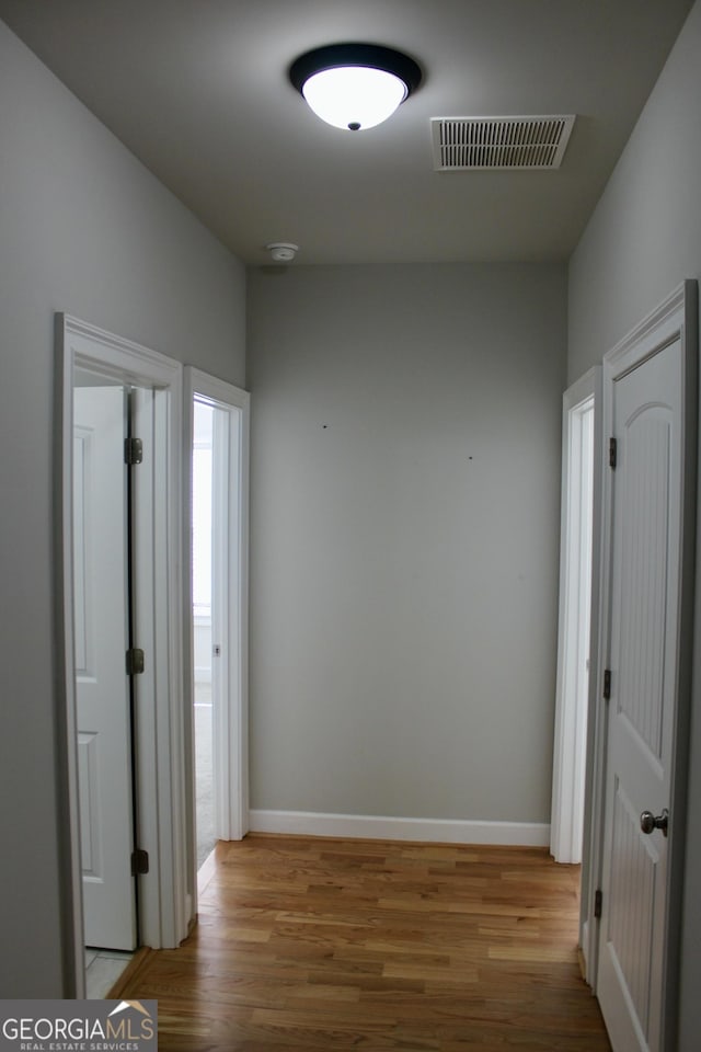 corridor with light wood-type flooring