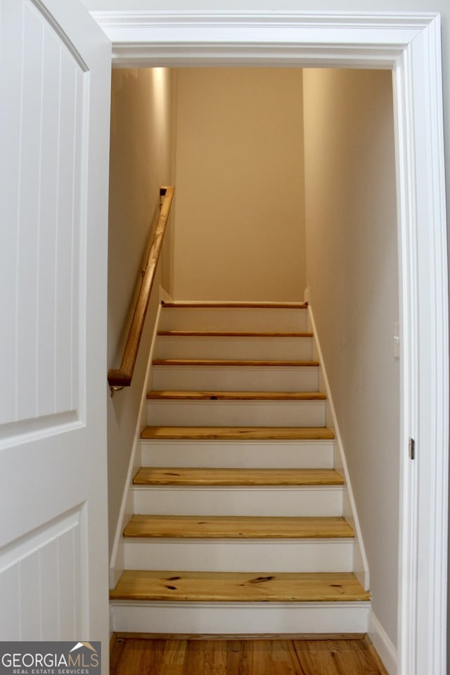 stairway with wood-type flooring