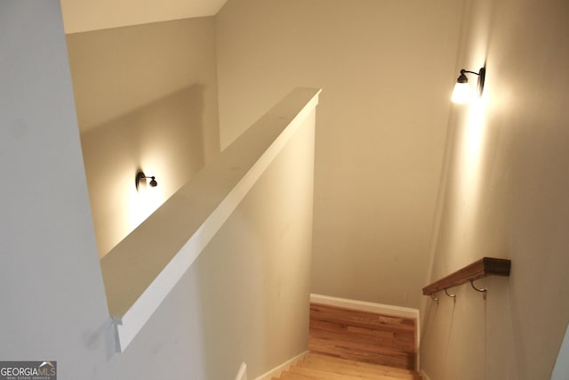 staircase with wood-type flooring