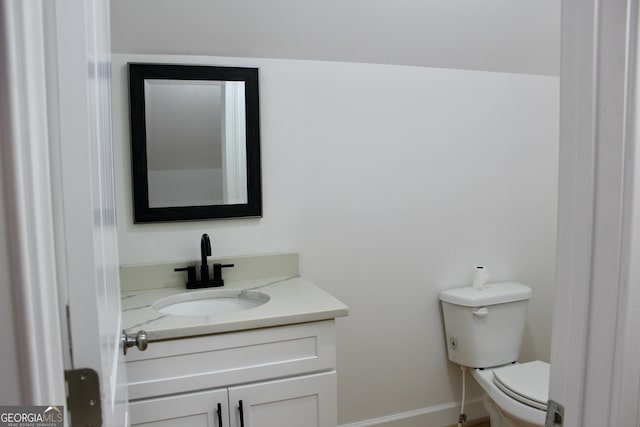 bathroom featuring toilet and vanity