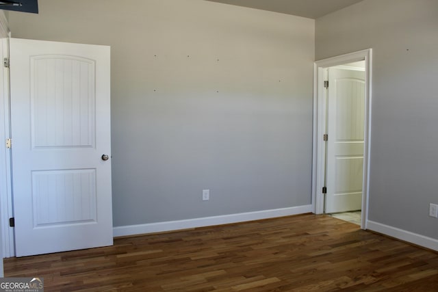 spare room with dark wood-type flooring