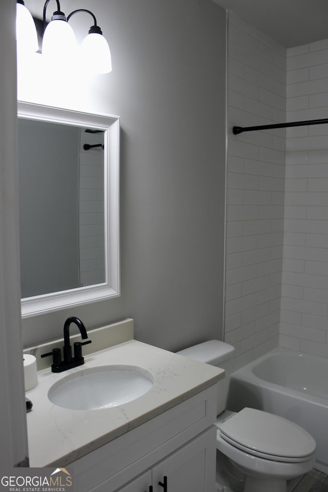 full bathroom featuring bathtub / shower combination, vanity, and toilet