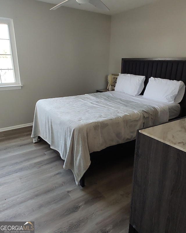 bedroom featuring ceiling fan and wood-type flooring