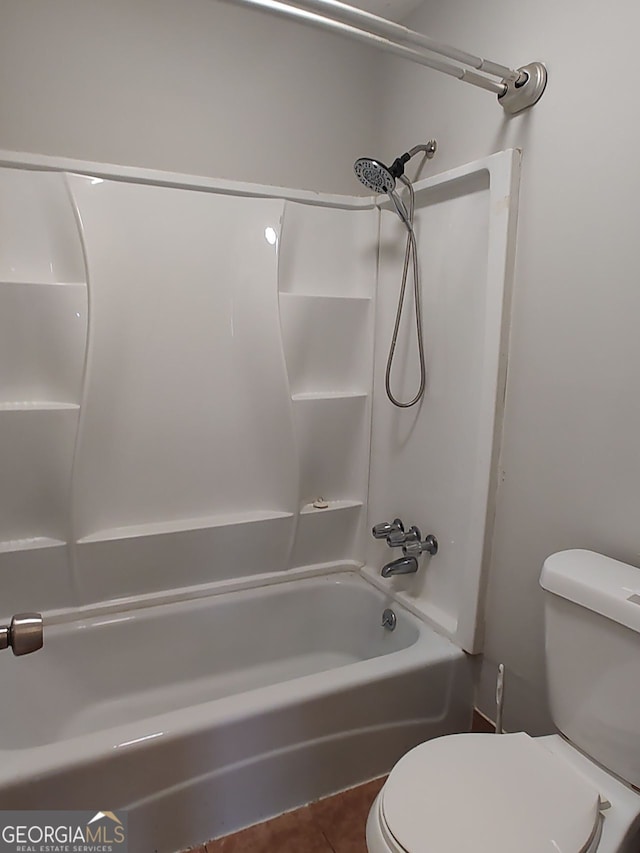 bathroom with toilet, tile patterned flooring, and bathing tub / shower combination