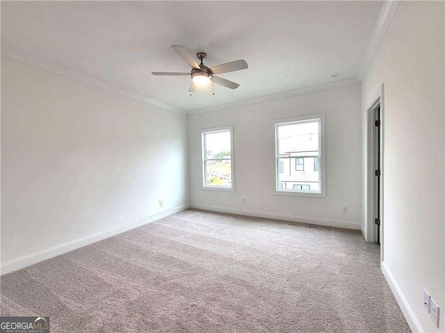 unfurnished room featuring ceiling fan, ornamental molding, and light colored carpet