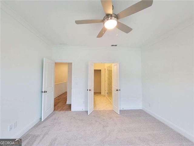 unfurnished bedroom with ceiling fan, light colored carpet, and ornamental molding