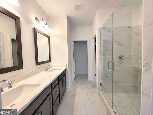 bathroom with a shower with shower door and vanity