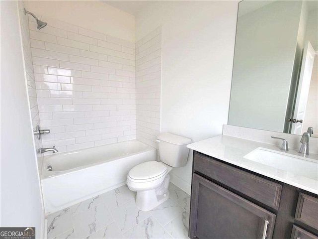 full bathroom with toilet, vanity, and tiled shower / bath