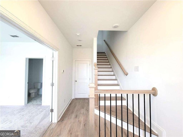 stairway featuring hardwood / wood-style floors