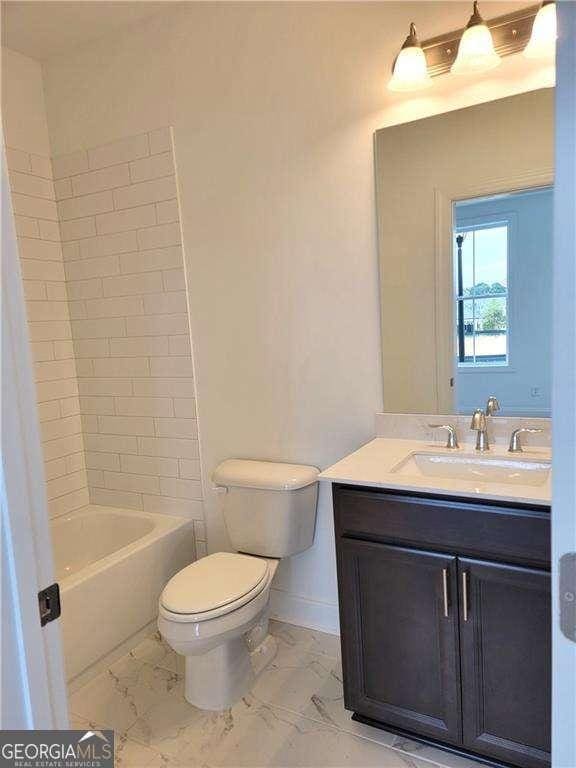 full bathroom featuring toilet, vanity, and shower / bathtub combination