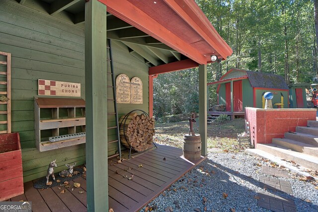 wooden terrace featuring a shed