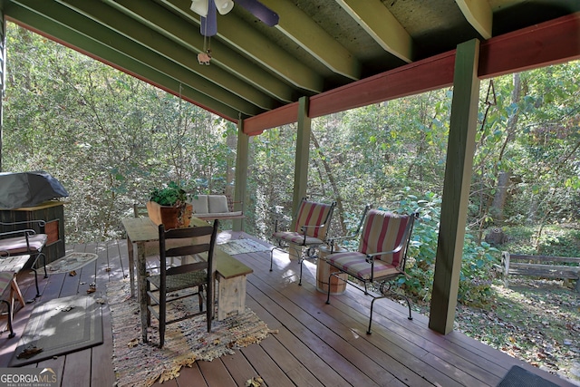 wooden deck with ceiling fan and grilling area