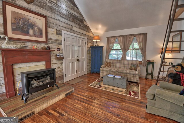 living room with dark wood-type flooring, vaulted ceiling, and wooden walls