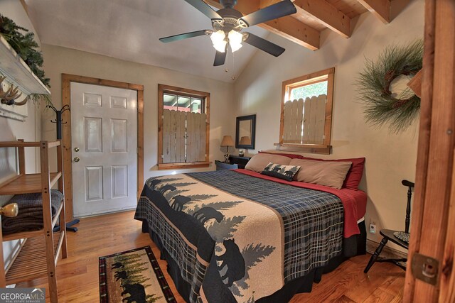 bedroom with lofted ceiling with beams, ceiling fan, and light hardwood / wood-style floors