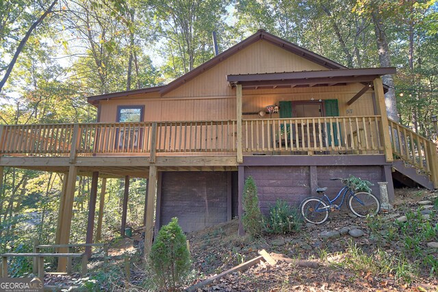 back of house with a wooden deck