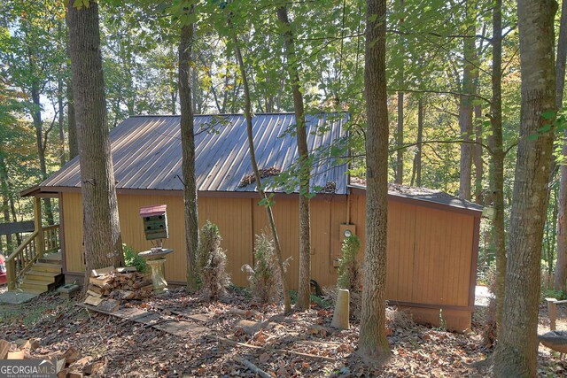 view of home's exterior with an outbuilding