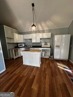 kitchen featuring white cabinetry, hanging light fixtures, white refrigerator with ice dispenser, and dark wood-type flooring