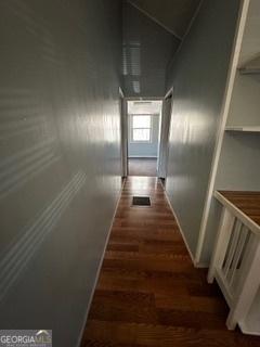 hallway with dark hardwood / wood-style flooring