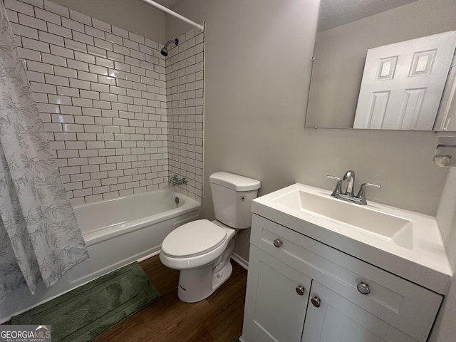 full bathroom featuring a textured ceiling, wood-type flooring, vanity, toilet, and shower / tub combo with curtain