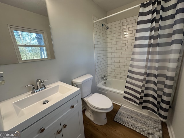 full bathroom with toilet, shower / bath combination with curtain, hardwood / wood-style flooring, and vanity