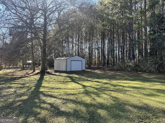 view of yard with a storage shed and a garage