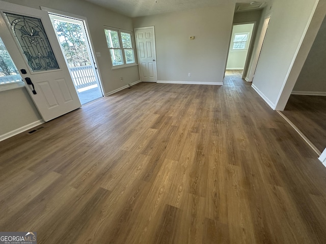 interior space with a textured ceiling and wood-type flooring