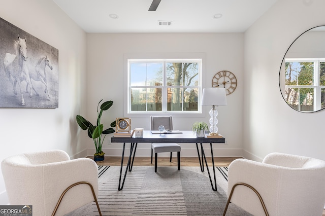 office area featuring ceiling fan, wood-type flooring, and a healthy amount of sunlight