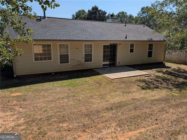 back of property with a patio and a yard