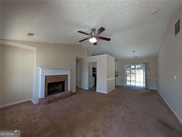 unfurnished living room with a textured ceiling, a brick fireplace, lofted ceiling, and ceiling fan with notable chandelier