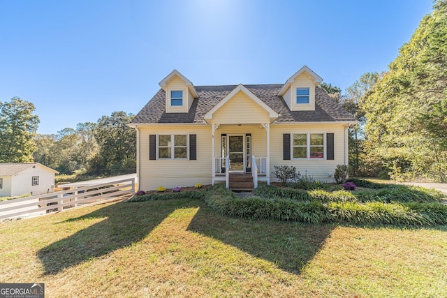 cape cod house with a front lawn