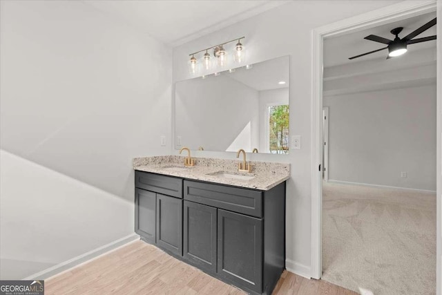 bathroom featuring ceiling fan, vanity, and wood-type flooring