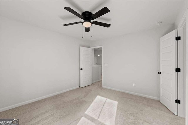 unfurnished bedroom with ceiling fan and light carpet