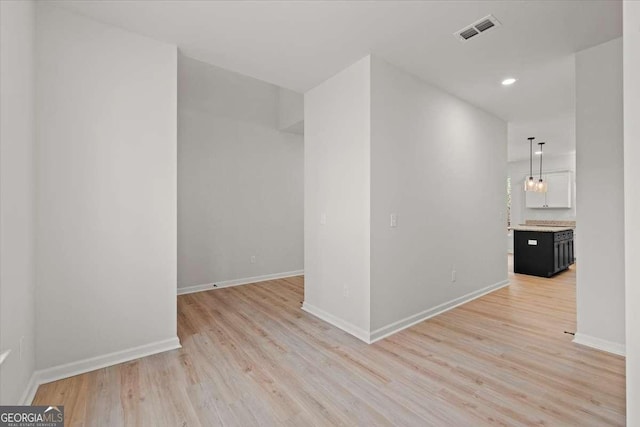 unfurnished room with light hardwood / wood-style flooring