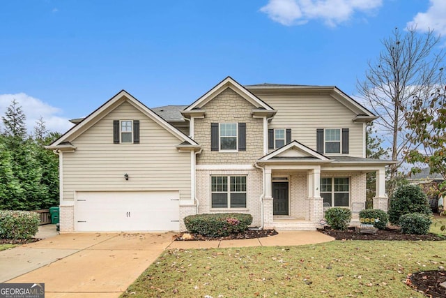 craftsman house with a garage, a front yard, and covered porch