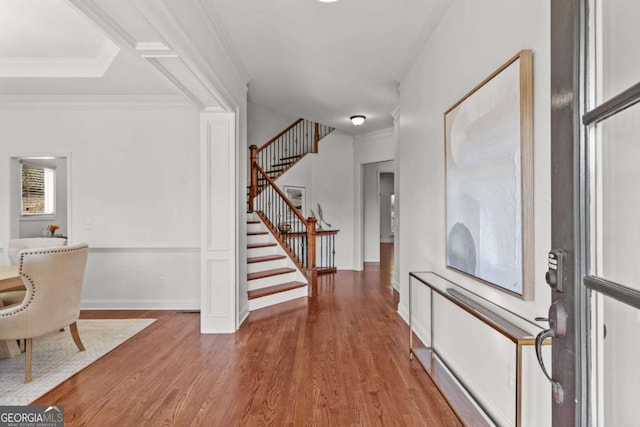 foyer with crown molding and wood-type flooring