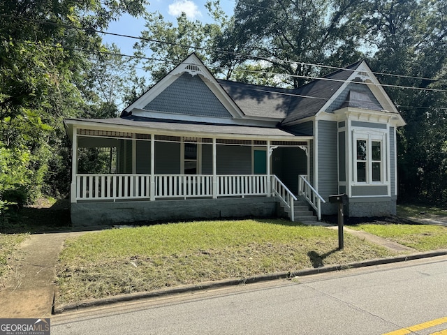 view of front of house with a front lawn and covered porch