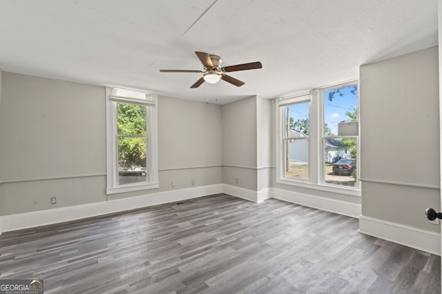 spare room featuring ceiling fan and hardwood / wood-style flooring