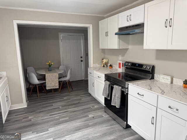 kitchen featuring light wood-type flooring, white cabinetry, dishwasher, and tasteful backsplash