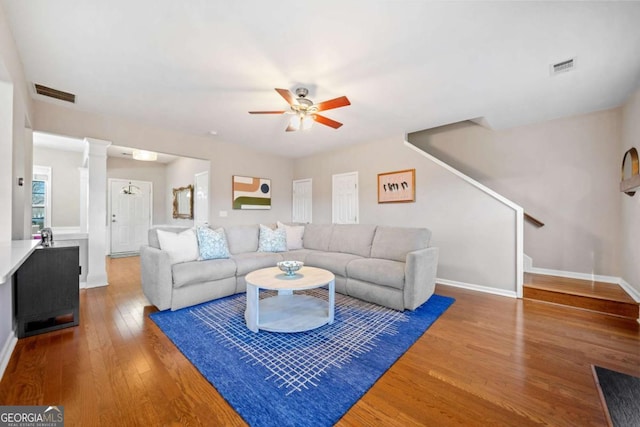 living room featuring ceiling fan and wood-type flooring