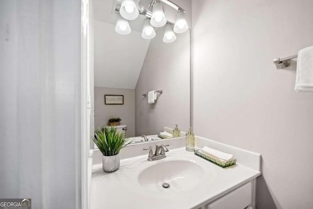 bathroom featuring vanity and vaulted ceiling