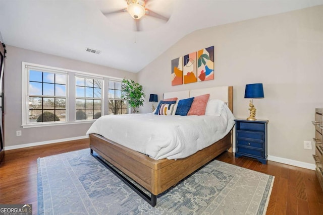 bedroom featuring ceiling fan, dark hardwood / wood-style floors, and lofted ceiling